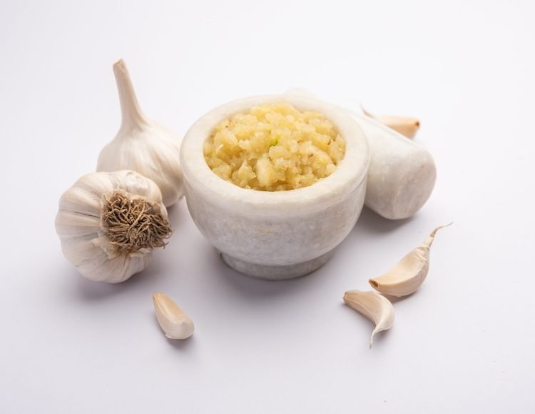 Garlic Paste or Lahsun Puree with raw whole, isolated over white background. Selective focus