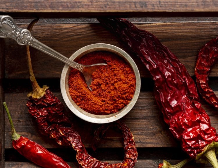 top-view-chili-peppers-wooden-tray-with-powder
